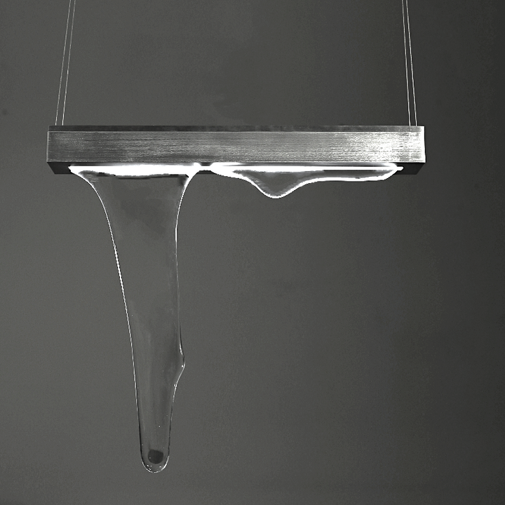The lighting design is hand-blown from glass and shaped like a flowing liquid
